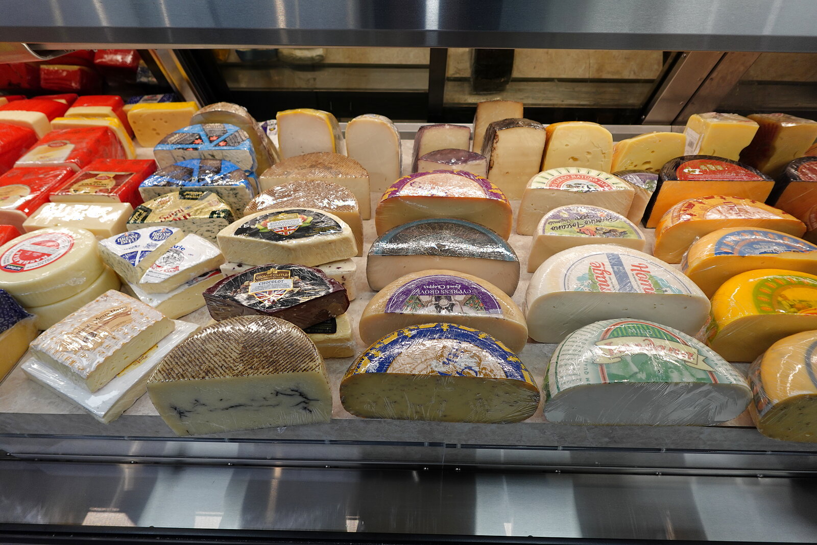 Cheese wheels and wedges at the Bathurst Village Market cheese counter